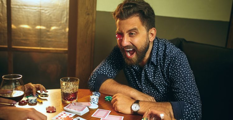 20240718 funny male female friends sitting wooden table men women playing card game hands with alcohol close up